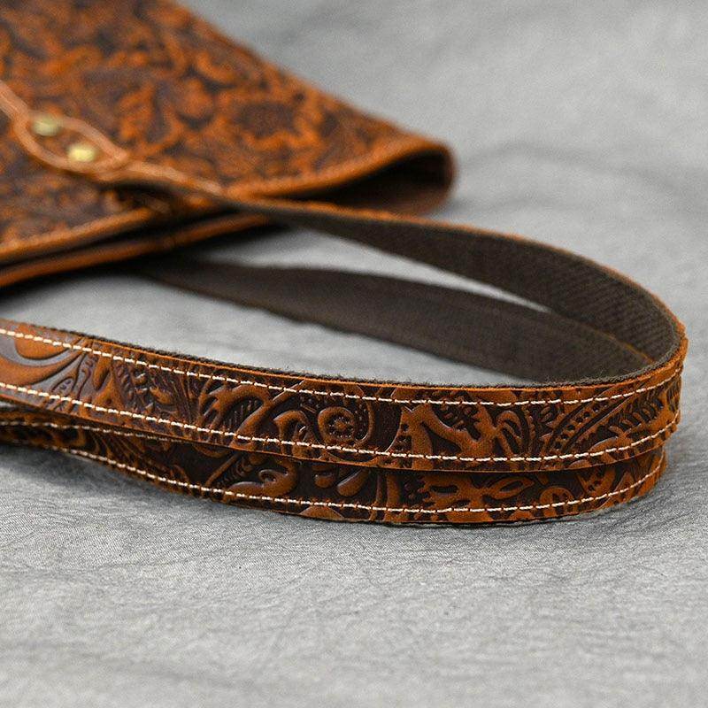 Close-up of a stylish designer shoulder bag for laptops with intricate patterns and sturdy straps.