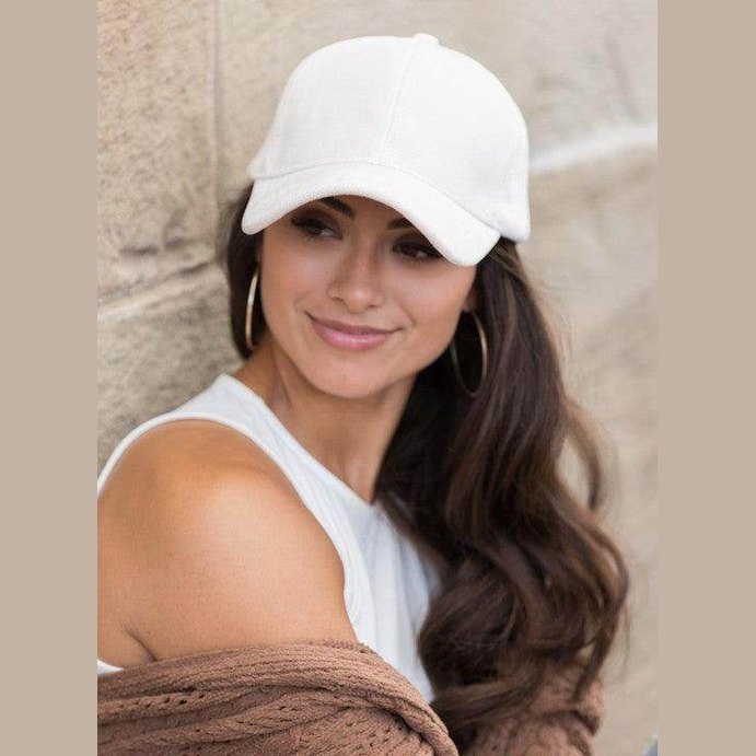 Aili's Corner women's designer velour caps in white, stylishly worn with casual outfit and earrings