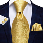 Elegant gold designer wedding ties for men featuring a paisley pattern, styled with a navy suit