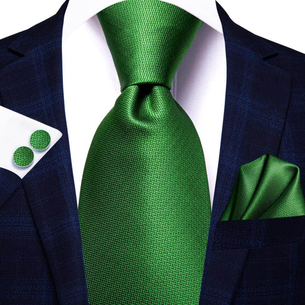 Stylish green designer wedding ties for men paired with a navy suit and matching pocket square