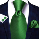 Stylish green designer wedding ties for men paired with a navy suit and matching pocket square