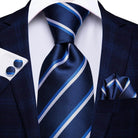 Elegant designer wedding ties for men in blue tones, paired with a matching pocket square and cufflinks