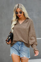 Stylish Women's dot v neck ruffle blouse in brown paired with denim shorts for a casual summer look