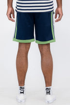 Back view of man wearing Double O Tape casual sweat shorts in navy with green accents