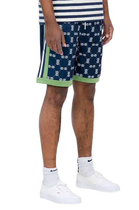 Double O Tape casual sweat shorts in navy blue with white pattern and green trim on model