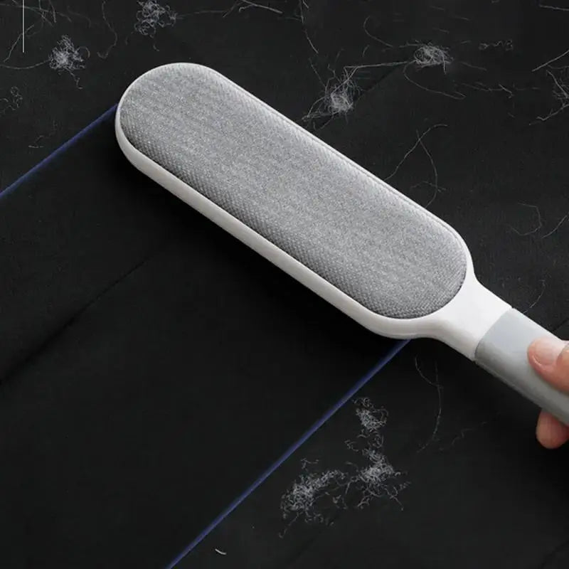 Double-sided pet hair remover brush with ergonomic handle for easy cleaning