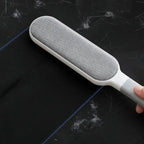Double-sided pet hair remover brush with ergonomic handle for easy cleaning