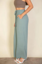 VacationGrabs women's drawstring waist wide leg pants in light blue with pockets styled with a cropped top and heels