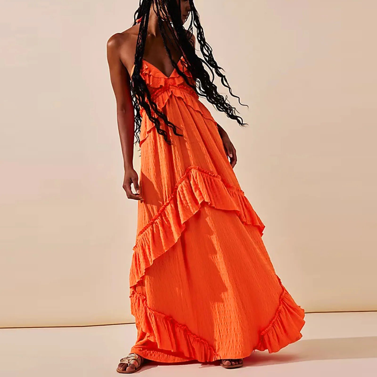 Women's orange tiered maxi dress for the summer, perfect for beach outings