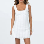 Women's white summer dress with scalloped edges, perfect for warm weather