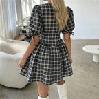 Women's plaid mini dress with puff sleeves, perfect for casual outings