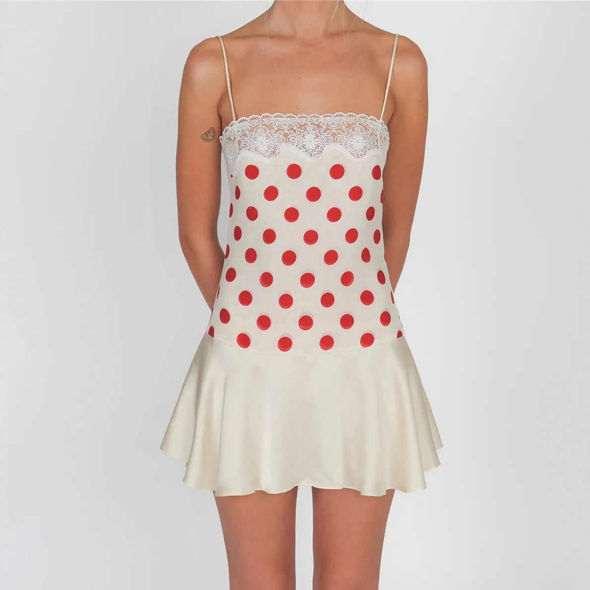 Women's mini dress in cream with red polka dots, perfect for summer outings