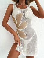 Women's crochet cover-up dress on the beach with floral design