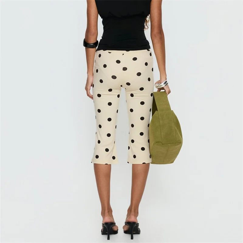 Women's polka dot cropped pants, stylish summer outfit with a chic handbag