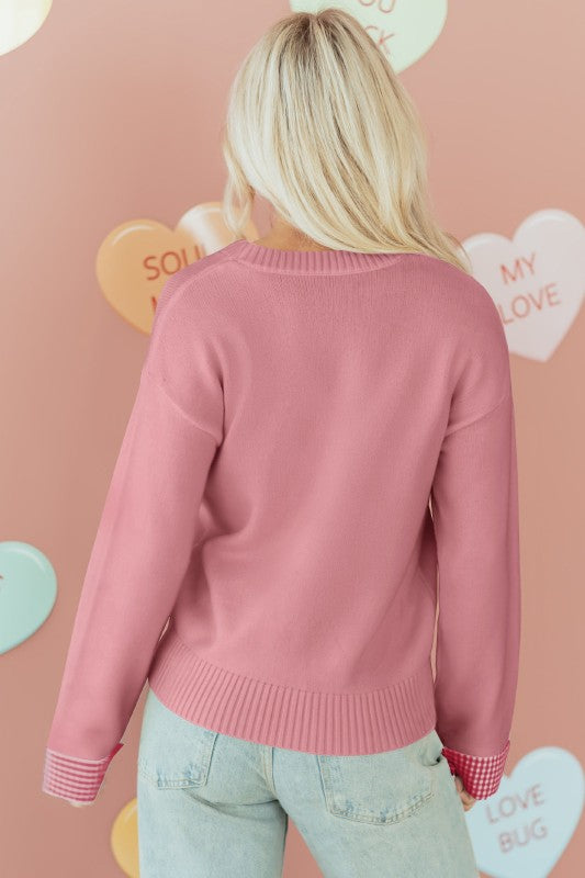 Back view of a Threaded Pear drop shoulder pink sweater with a relaxed fit and ribbed hem