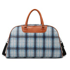 Plaid duffle bag with tan leather accents, perfect for travel