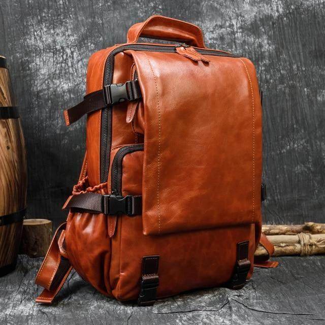 Durable travel backpack for men in rich brown leather with adjustable straps and multiple pockets
