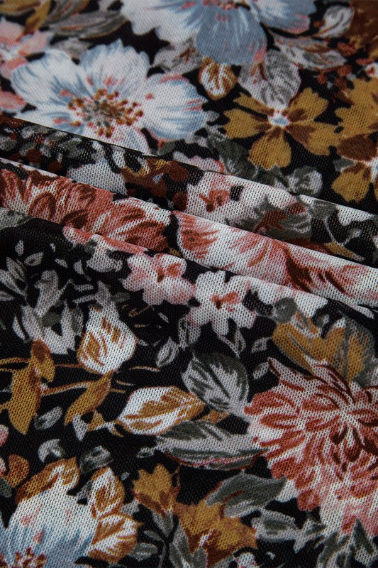 Close-up of JUNIPER BLVD mock neck floral blouse for women featuring vibrant floral patterns