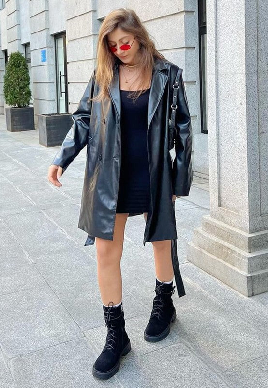 Stylish outfit featuring tan suede lace up boots for women with a black dress and leather coat