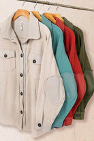Collection of ZENANA women's elbow patch fleece shacket in various colors hanging on a rack