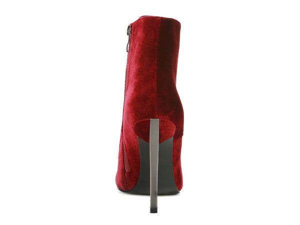 Elegant high heeled boots in red suede with a sleek design and zipper closure for stylish wear