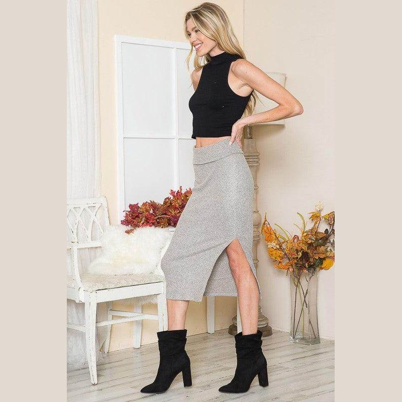 Trendy women's elegant slit skirt in gray, styled with a black crop top and black ankle boots