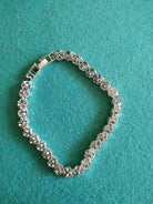 Elegant vacation jewelry bracelet with sparkling stones on a turquoise background