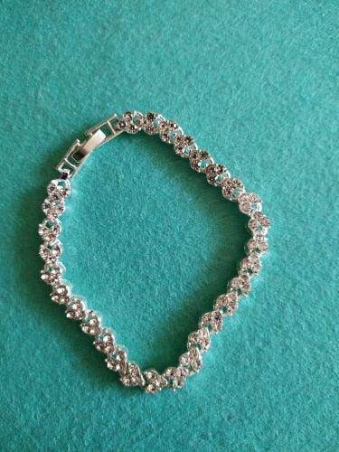Elegant vacation jewelry bracelet with sparkling stones on a turquoise background
