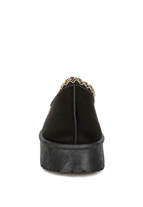 Black embroidered platform slip-on shoes with stylish detailing and comfortable sole