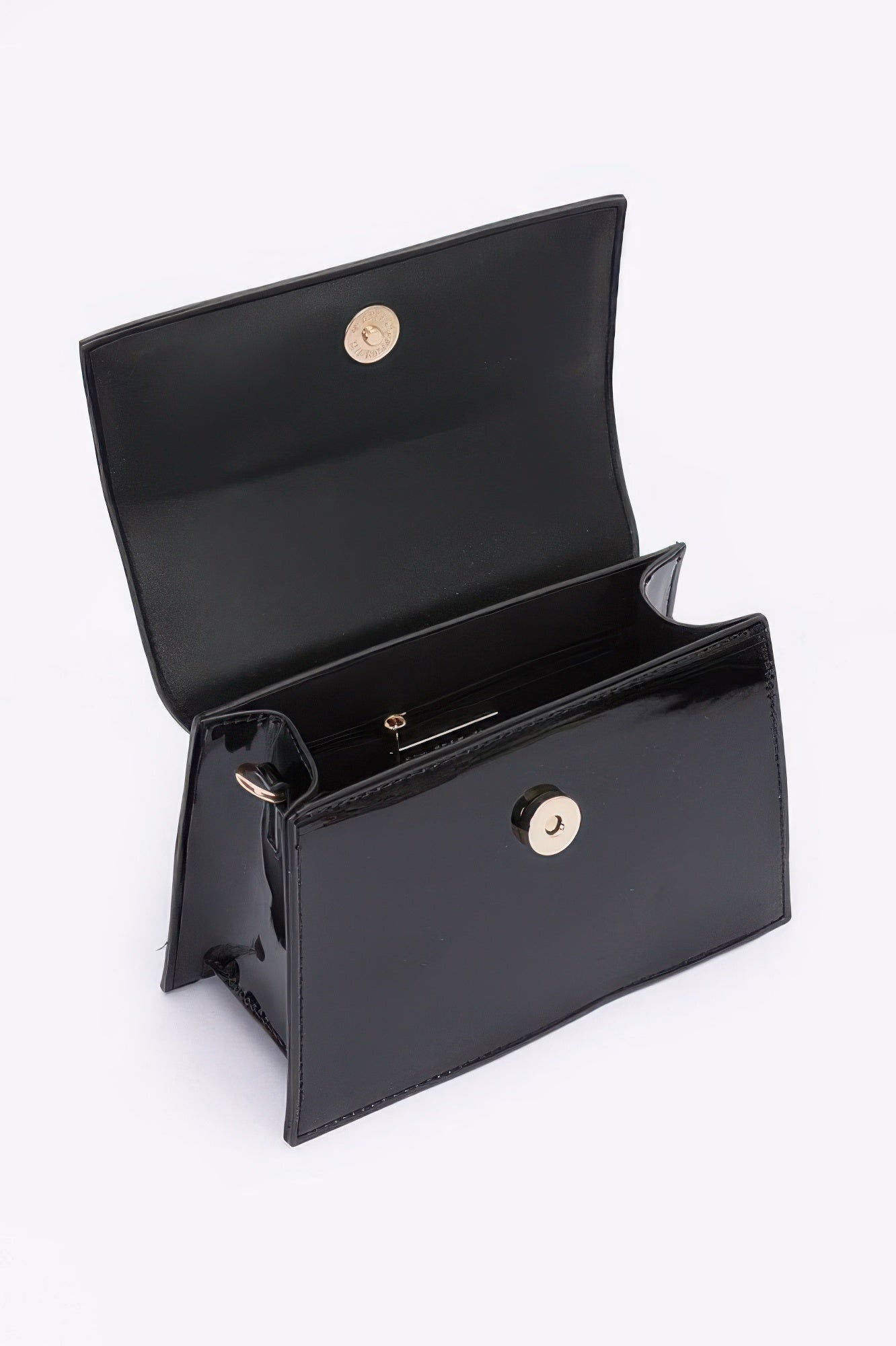 Stylish black enamel top handle crossbody bag with a zipper pocket and snap closure