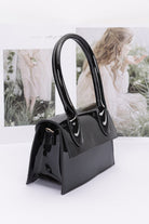 Chic enamel top handle crossbody bag in glossy black with a modern design and spacious interior