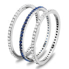 Set of three Women's Rings including an eternity band with blue stones and sparkling white stones