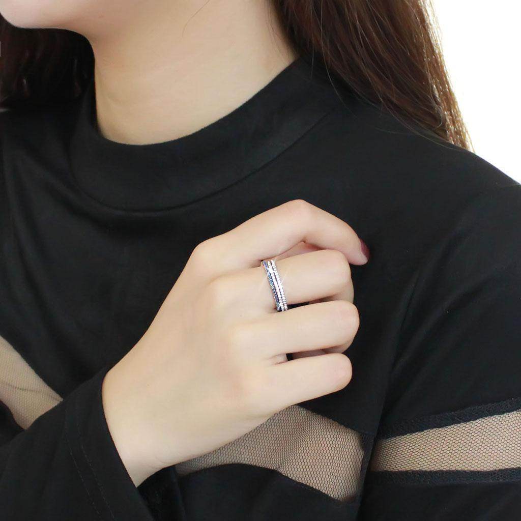 Women's eternity band with blue stones featuring a sleek design worn on a hand