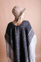 Leto Accessories ethical fashion bucket hat in beige, styled with a cozy poncho for a chic look