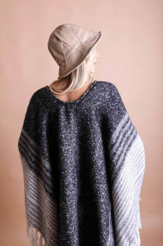 Leto Accessories ethical fashion bucket hat in beige, styled with a cozy poncho for a chic look