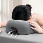 Gray face down pillow for massage, providing comfort during treatments