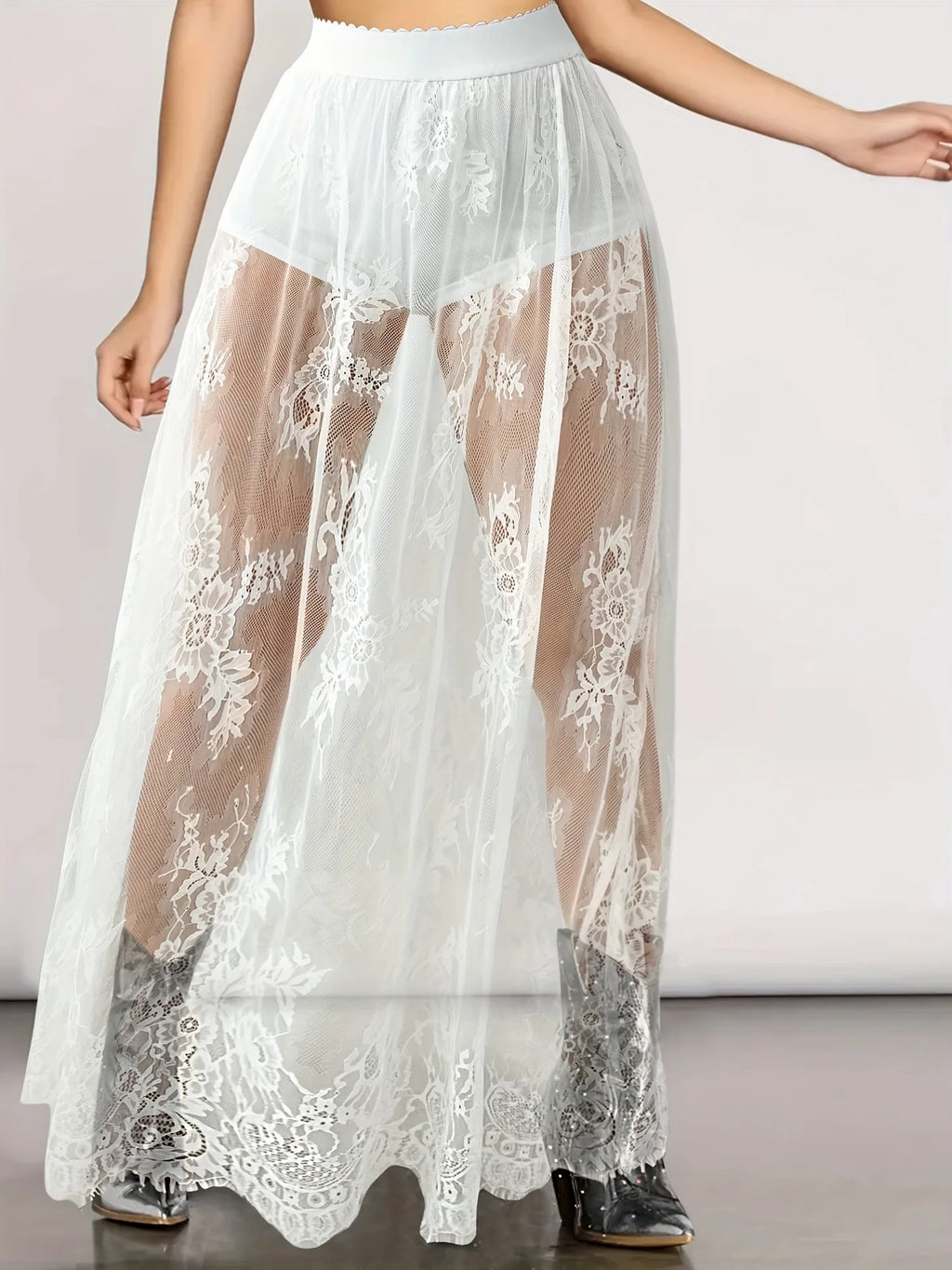 White sheer lace skirt with shorts featuring floral patterns and high waistband