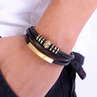 Stylish black fashion wristbands for men featuring braided and metal accents