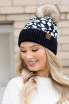 Aili's Corner fashionable animal print beanie in black and white with a fluffy pom pom on top