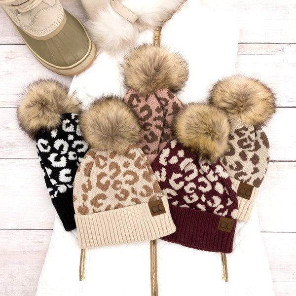 Collection of fashionable animal print beanie hats with faux fur pom poms from Aili's Corner