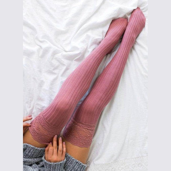 Fashionable knee high socks in soft pink with ribbed texture, perfect for stylish layering and comfort