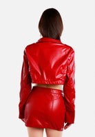 Back view of a red faux leather crop jacket for women, styled with a matching skirt