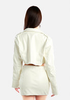 Back view of a stylish women's faux leather crop jacket in cream color, perfect for trendy outfits