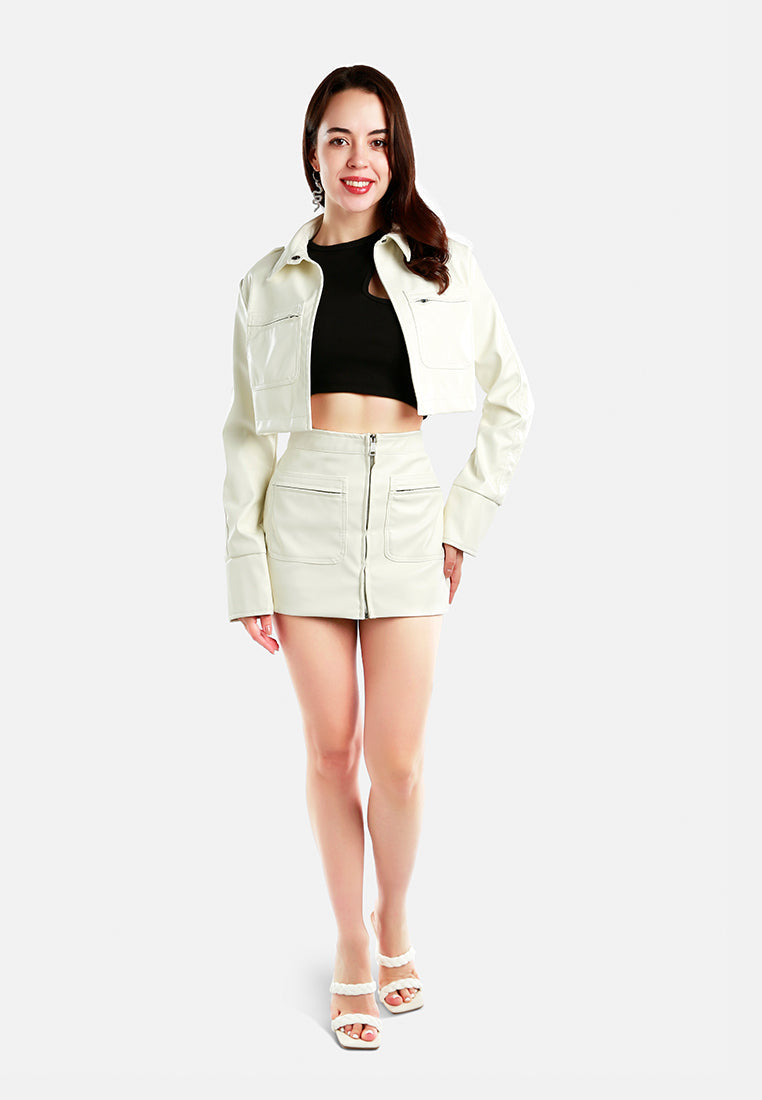 Stylish women's faux leather crop jacket paired with a matching skirt for trendy outfits