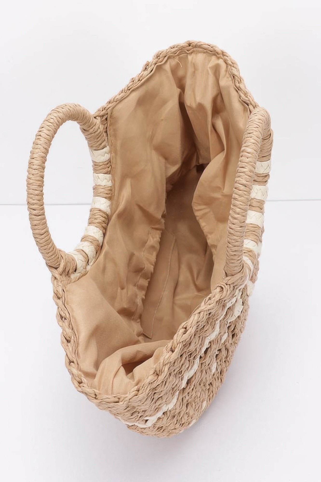 Inside view of a VacationGrabs faux straw tote bag with a spacious tan interior and braided handles