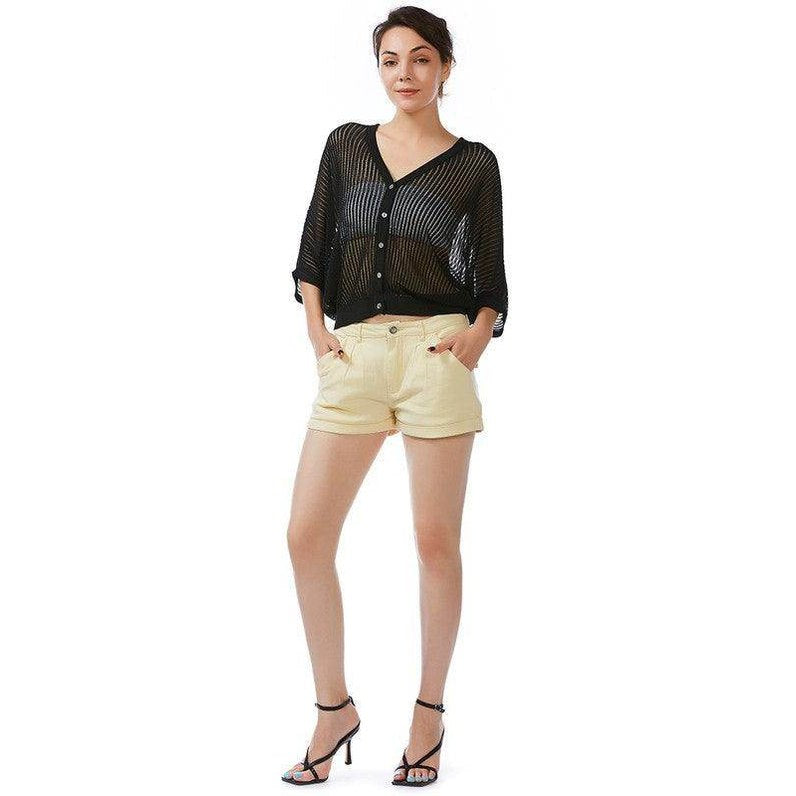 Model wearing Rag Company flap pocket summer shorts in light yellow with a stylish black top