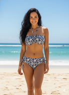 VacationGrabs floral bandeau bikini set with halter top and adjustable tie bottoms on a beach