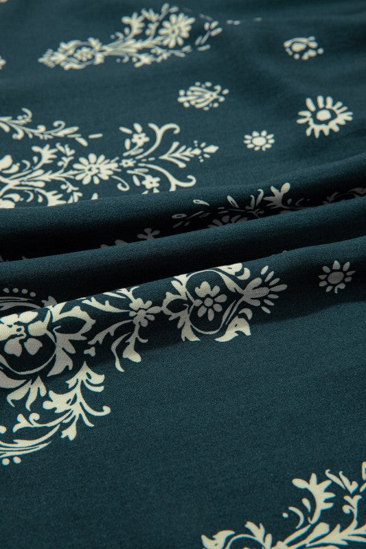 Women's floral dress in teal fabric with white patterns, perfect for casual outings