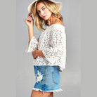 Ivory Felix floral lace blouse for vacation styled with denim shorts and a sun hat