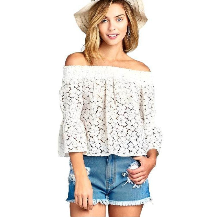 Ivory Felix floral lace blouse for vacation styled with denim shorts and a summer hat